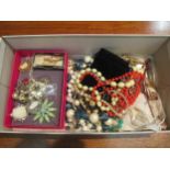 A tray of costume jewellery including bead necklaces and brooches
