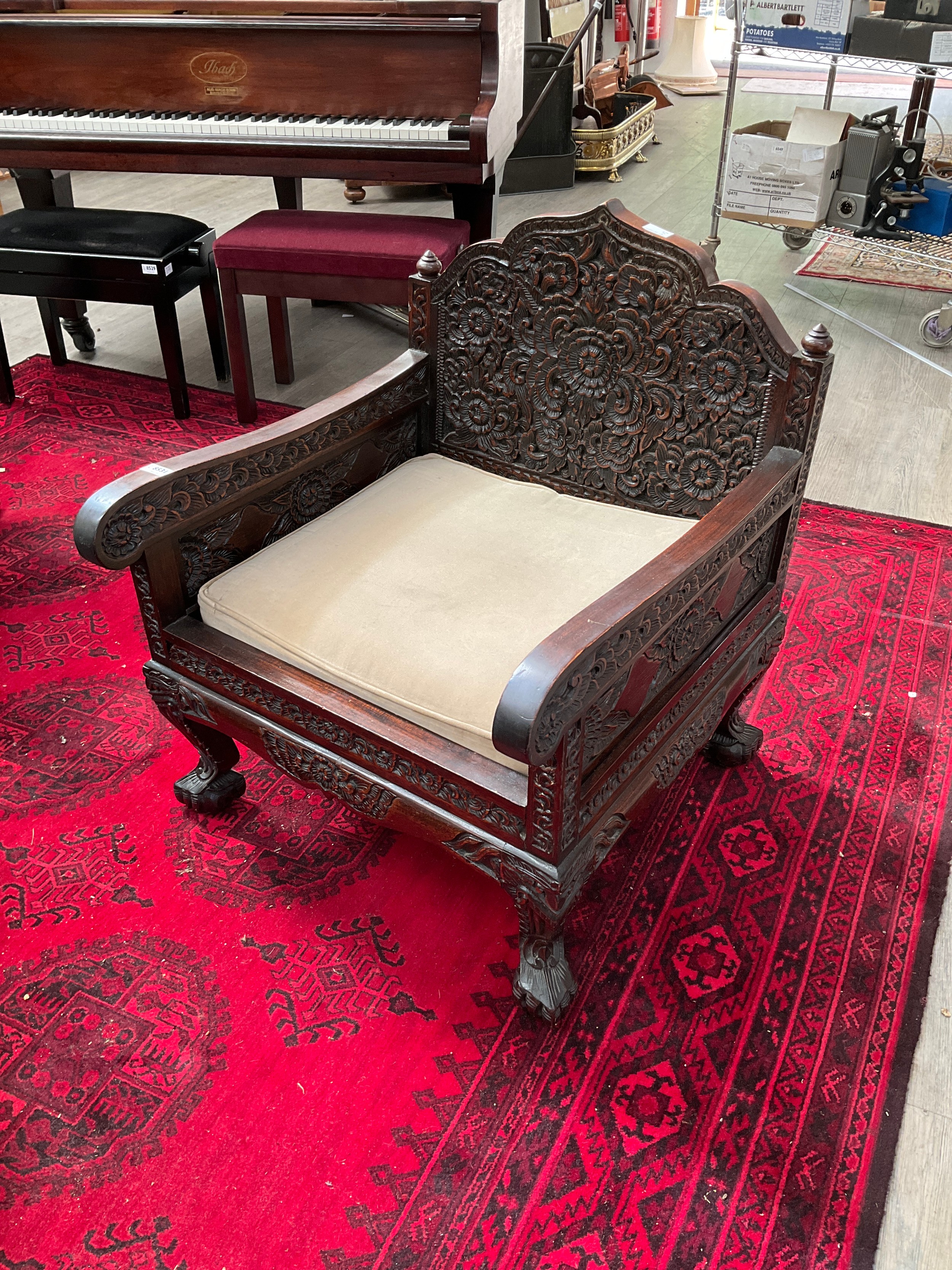 An early 20th Century Chinese rosewood lounge suite consisting of four heavily carved armchairs - Image 2 of 2