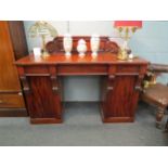 A mahogany sideboard with three drawers and wine cupboard within pedestal, 117cm high x 153cm wide x