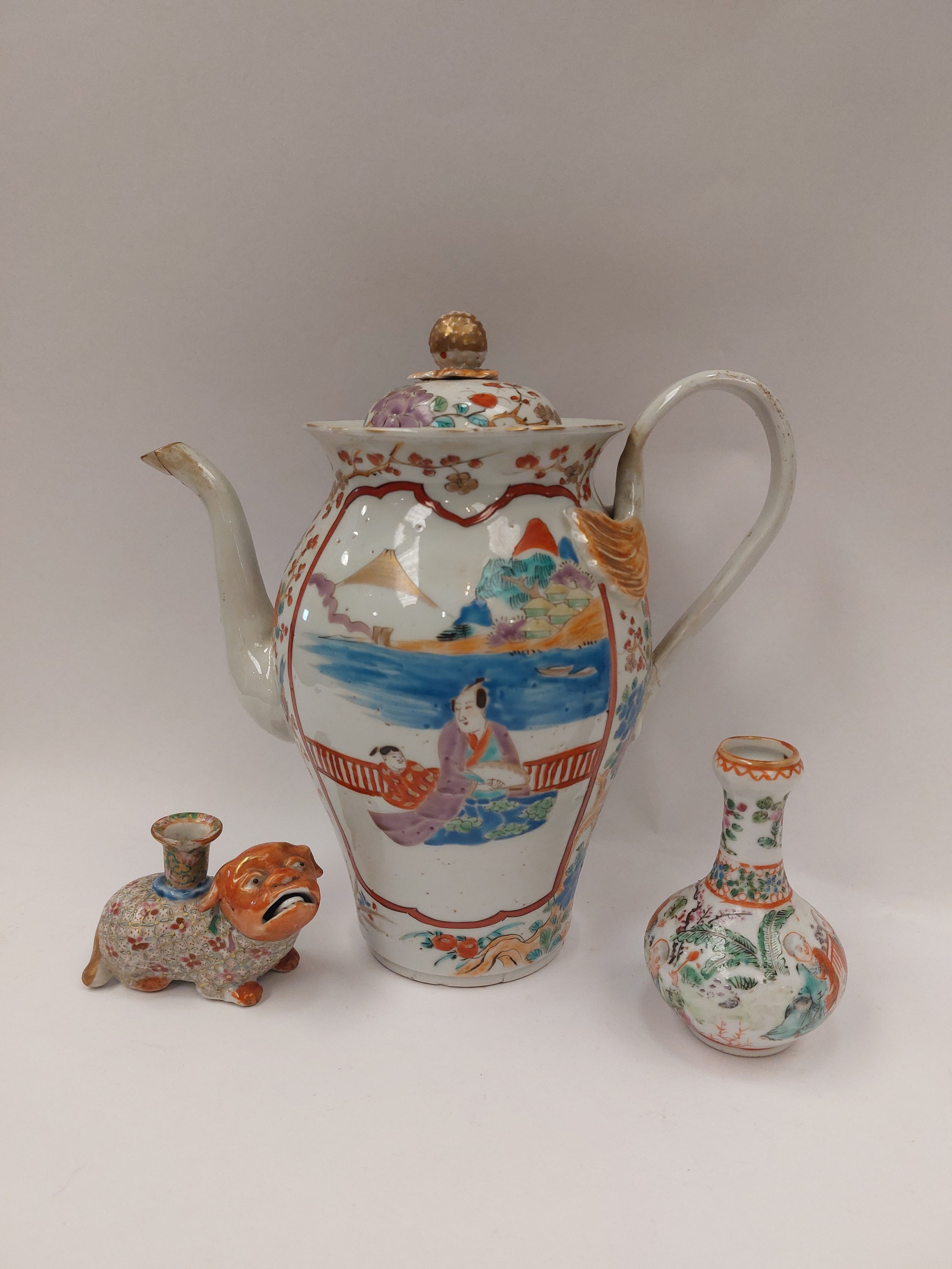 An Oriental coffee pot with character marks to base together with a figure of a dog and a