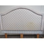An upholstered and padded headboard, double bed size, pink and blue lattice floral pattern and two