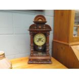 An American walnut mantel clock with Roman dial and spindle mouldings