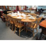 A pine dining table with eight dining chairs