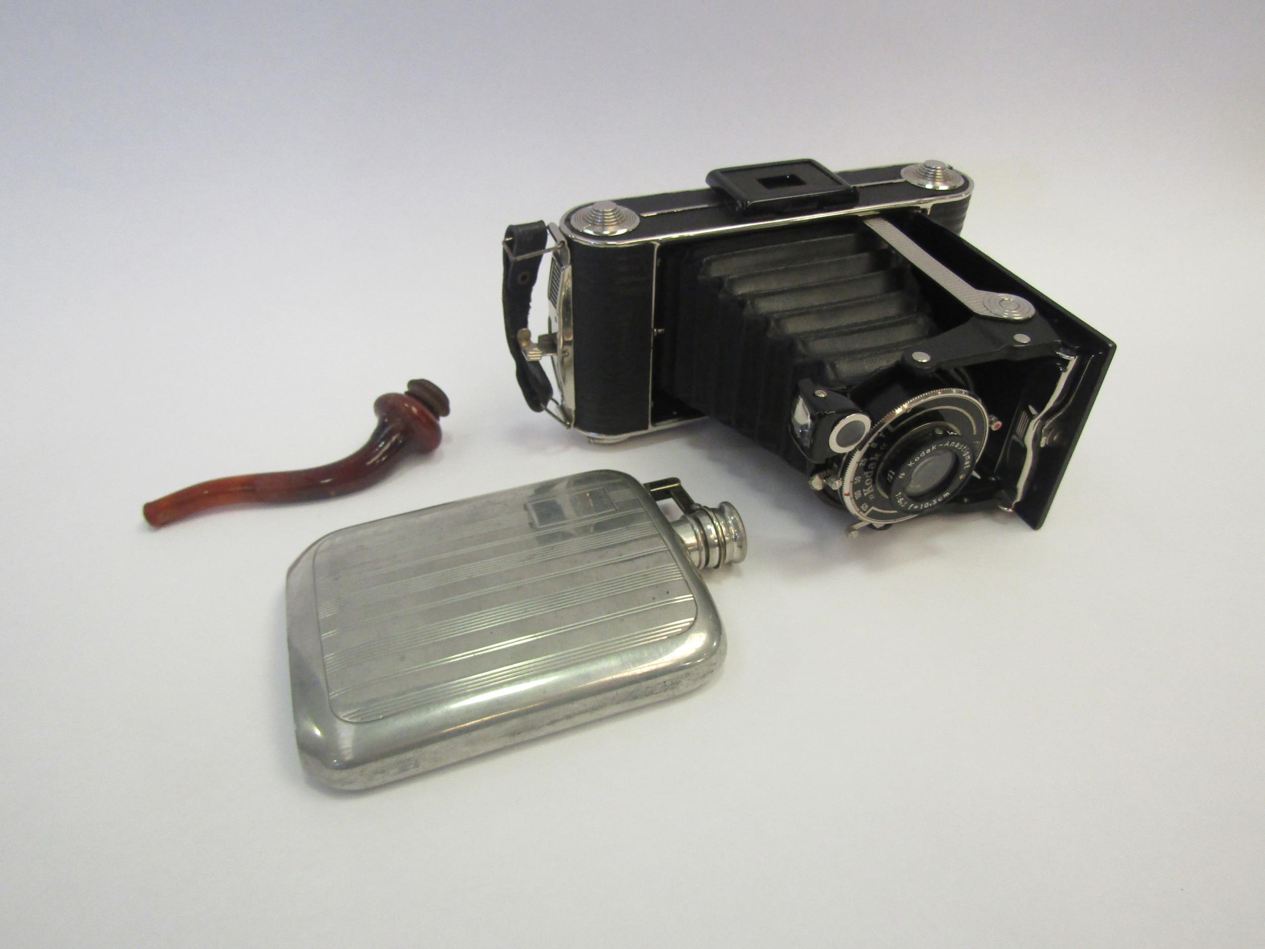 A cased Kodak Junior 620 camera, a 4oz hip flask and a cased pipe, possibly for opium