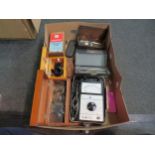 A box of scientific instruments, glass lenses, etc