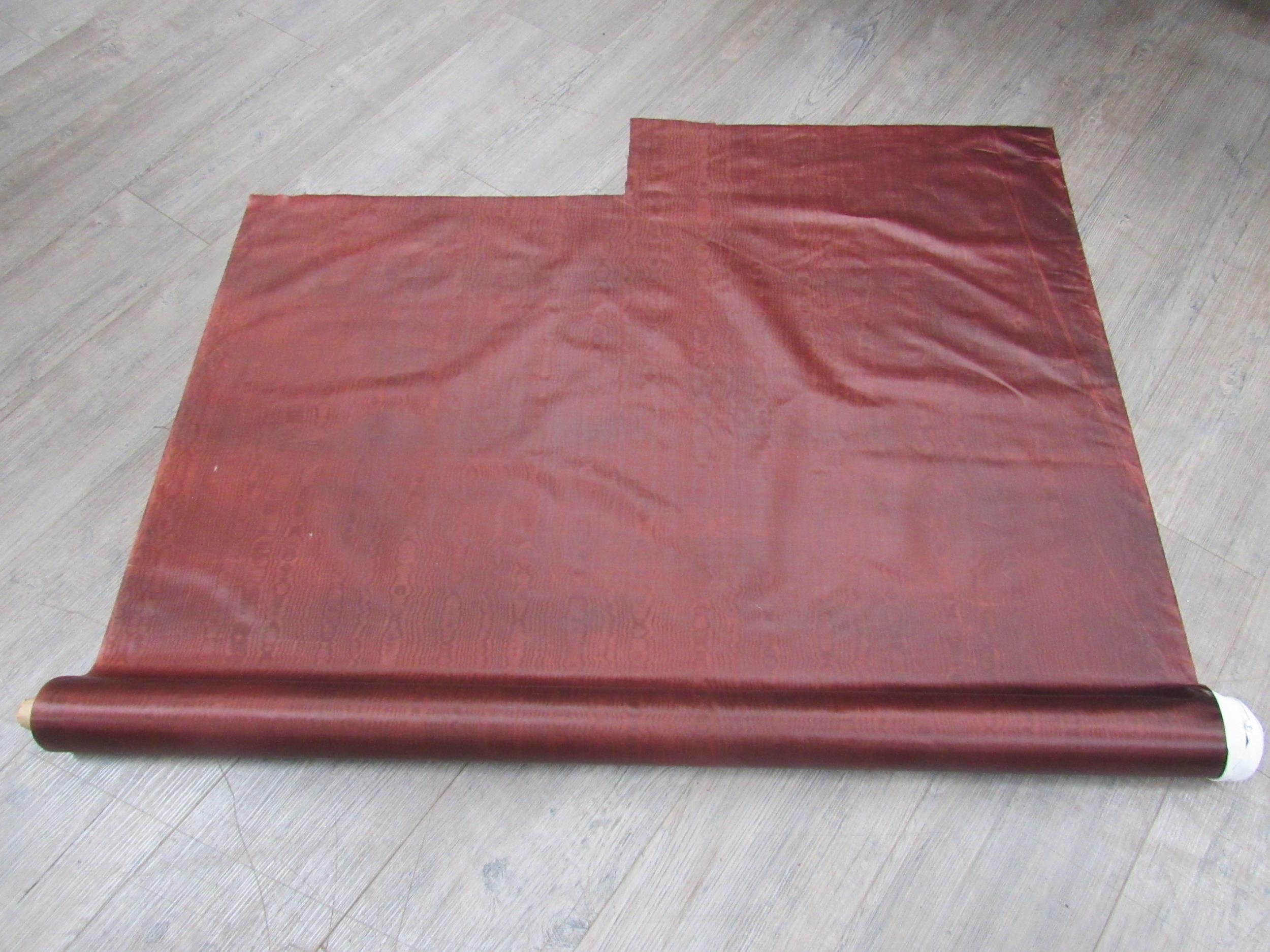 A bolt of brown moiré effect fabric and 2.5 metres approx. of black polyester double georgette