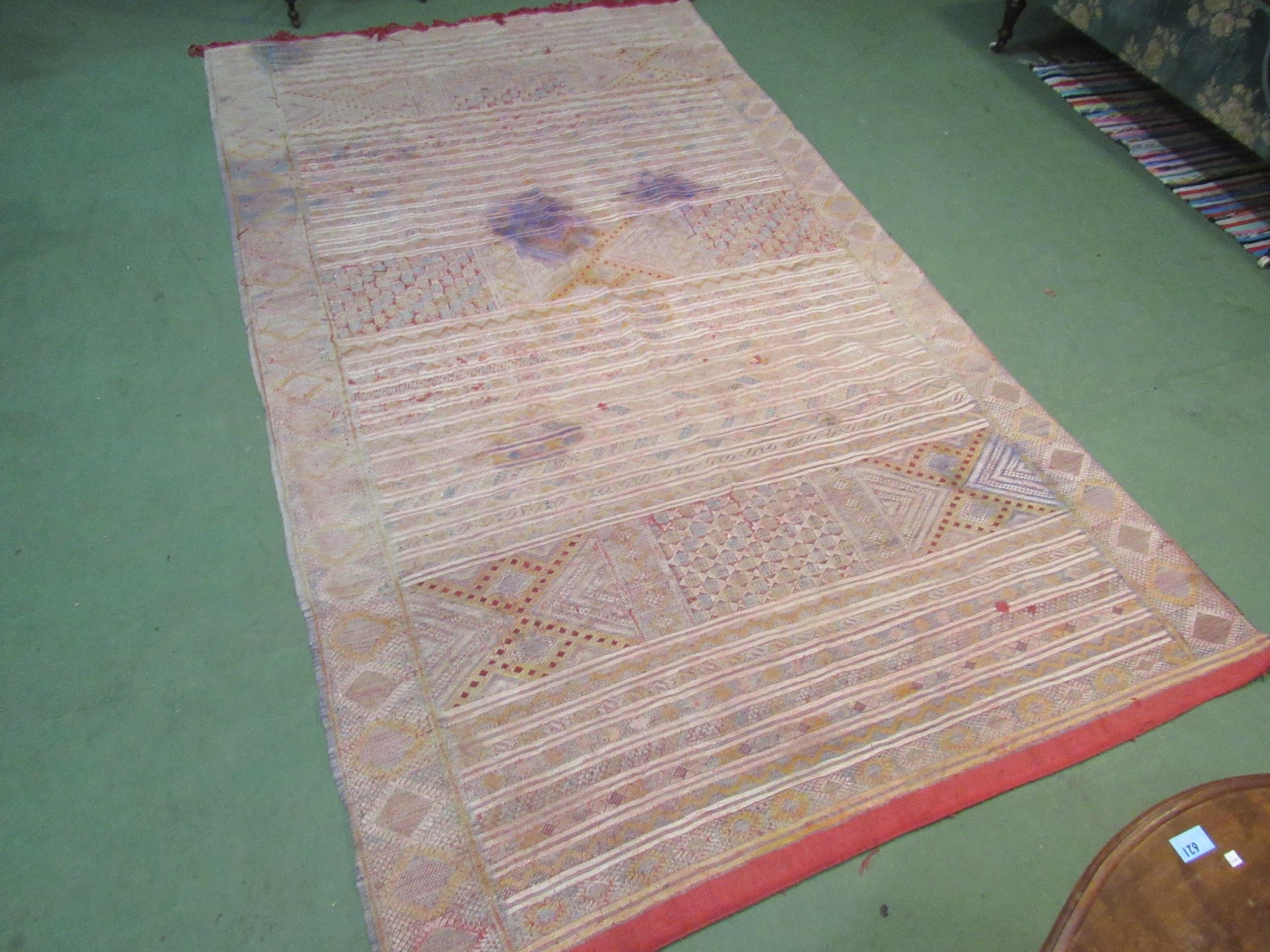An Eastern hand woven geometric design rug, badly stained, a/f, 316cm x 178cm