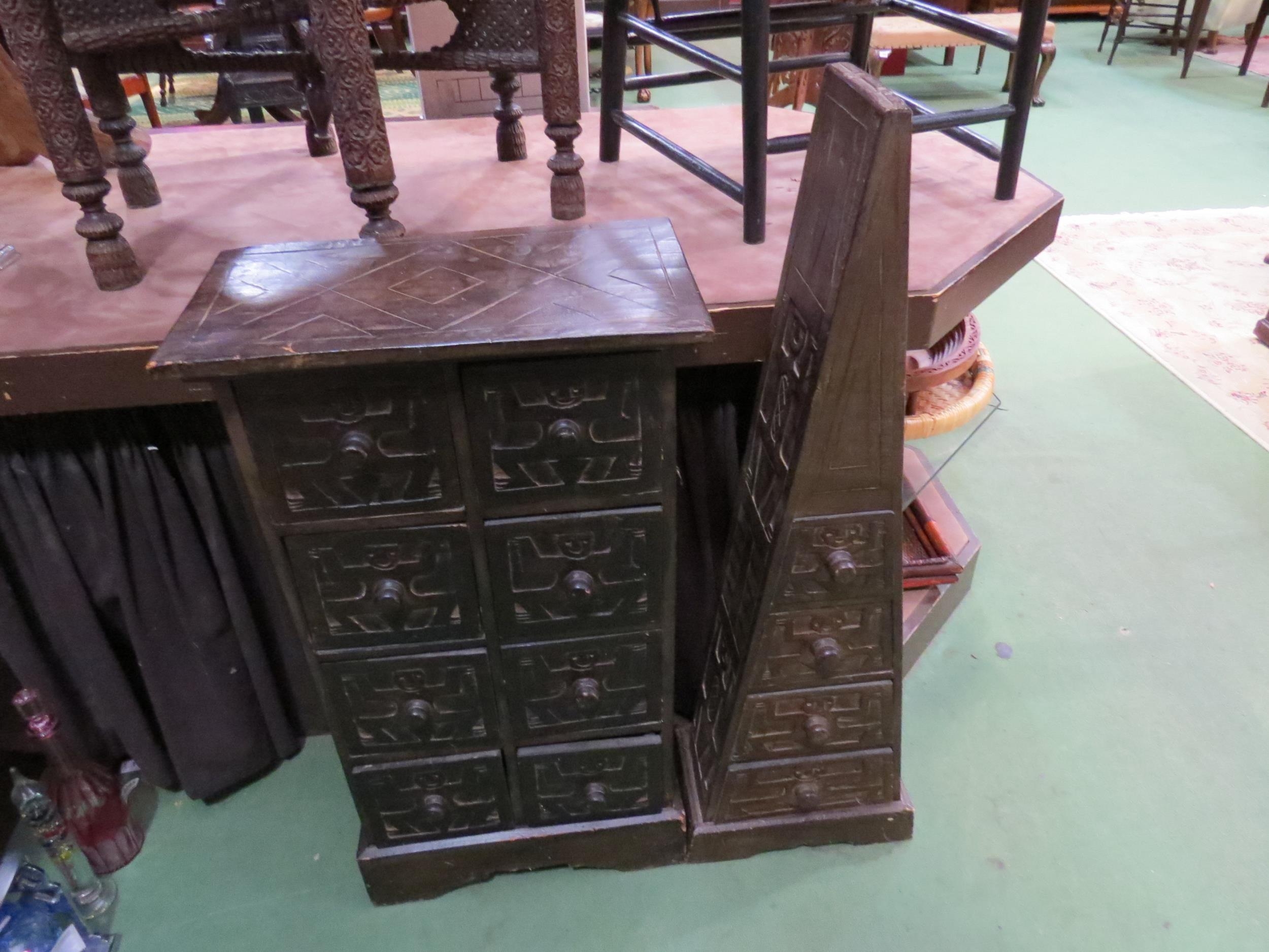 A small carved African wooden chest of eight drawers, 84cm high x 46cm wide, together with another