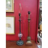 A wood and brassed effect column form table lamp with plinth base and a black metal table lamp