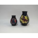 Two Moorcroft vases, one bearing paper stamp By Appointment to The Late Queen Mary, 10cm tall and