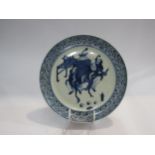 A blue and white Chinese hand painted plate depicting an interior scene, a/f, 23.5cm in diameter