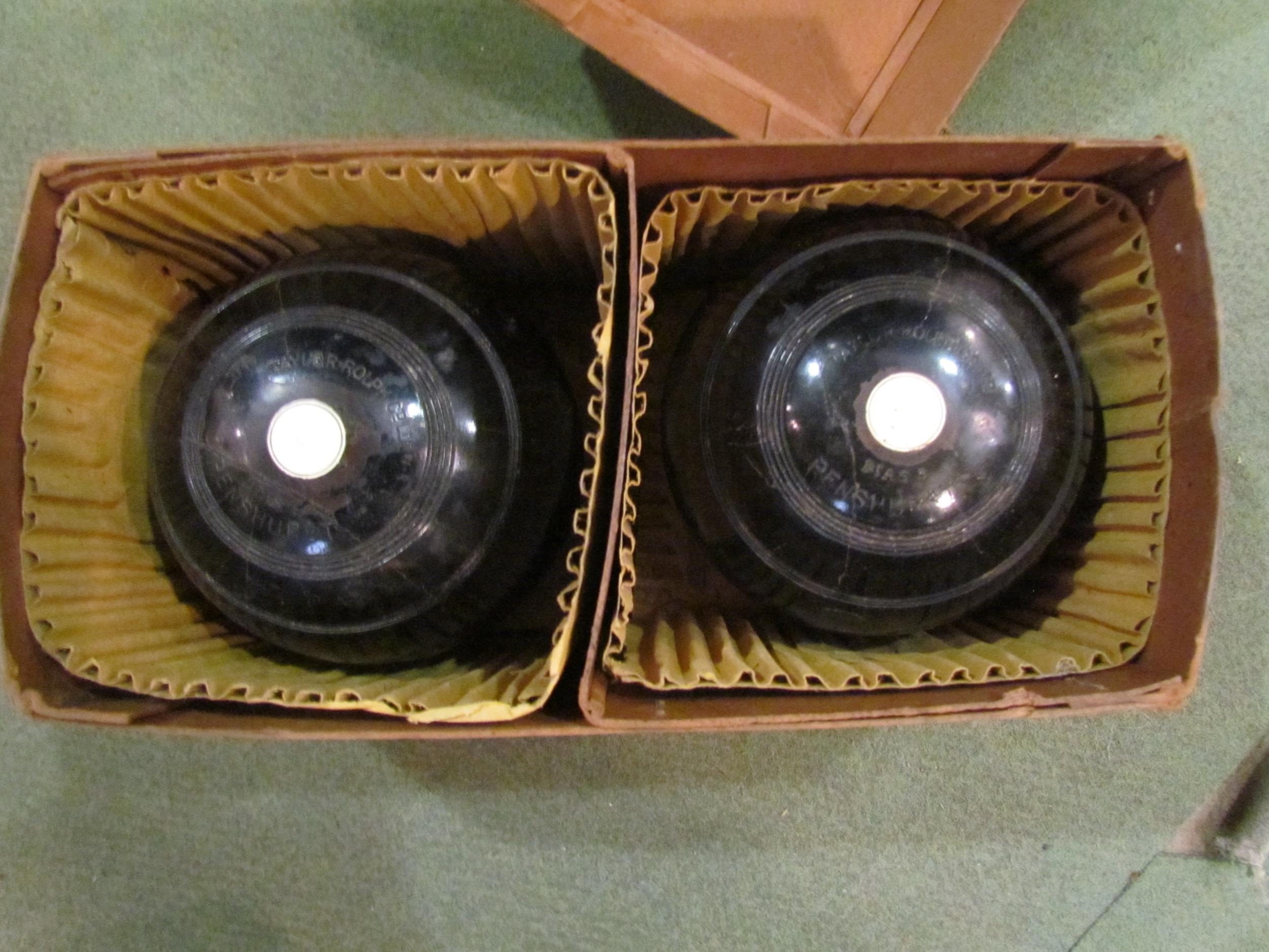 A pair of Taylor Ralph lignum vitae lawn balls in original box