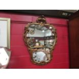 An ornate gilt framed wall mirror, 115cm high x 82cm wide total