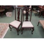 A pair of George II revival mahogany chairs with pierced vase shaped central splat on "C" scroll