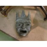 A carved wooden tribal mask, 30cm tall