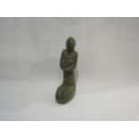 A carved stone figure of mother nursing a child, 26cm tall