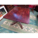 Circa 1800 a mahogany tilt top table, the reeded edge top over a turned column and outswept legs