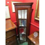 A mahogany corner cabinet with glazed panel doors, 150cm high x 51cm wide x 30cm deep