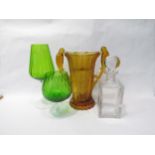 An etched glass decanter, two green oversized glasses, an amber art deco glass twin handled vase (