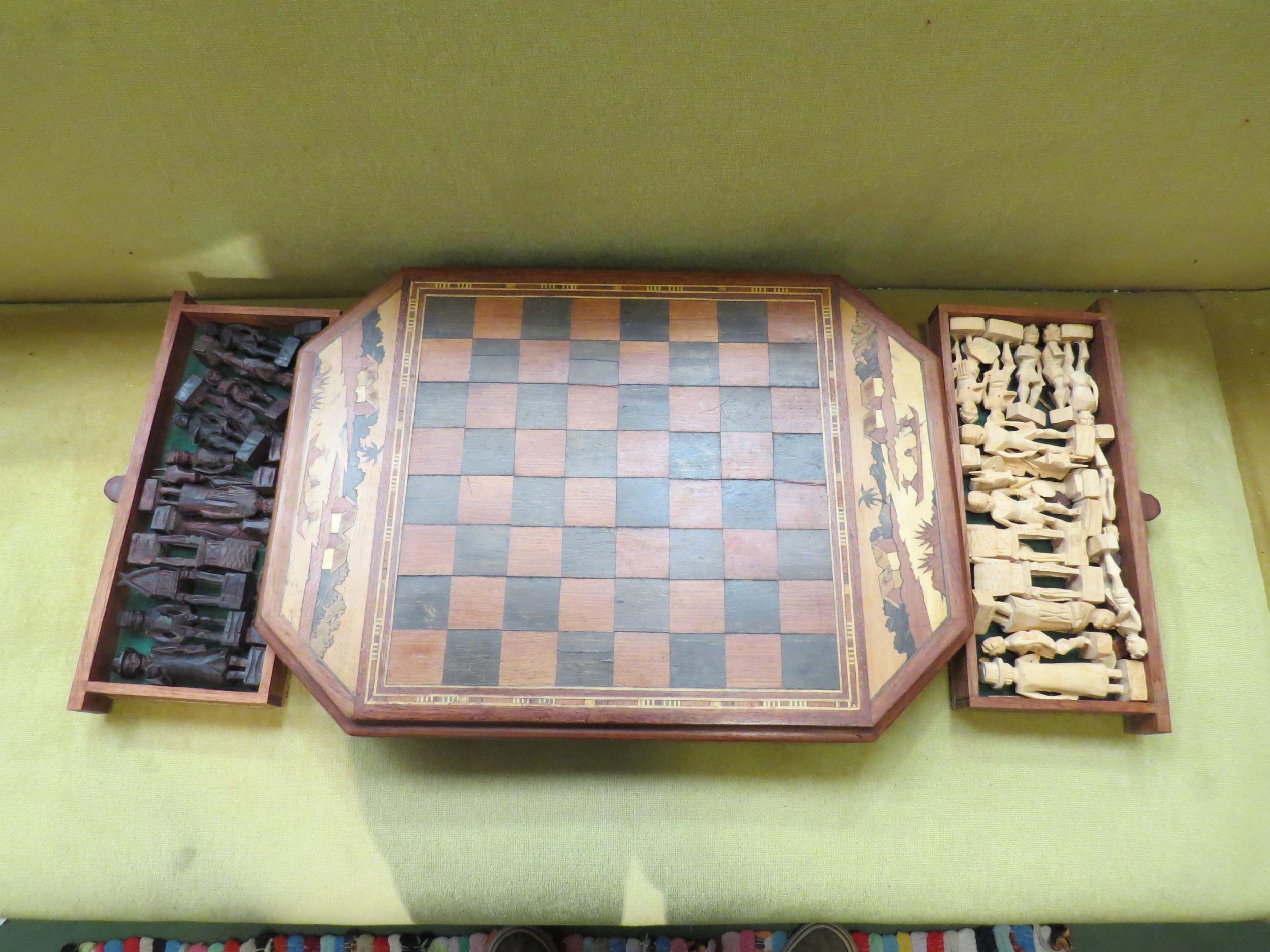 A carved Madagascan chess set with figural pieces