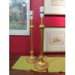 A pair of slender form gilt effect Regency style table lamps, flared form circular base