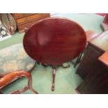 A George III revival mahogany revolving circular tilt top wine table on a bird cage action turned