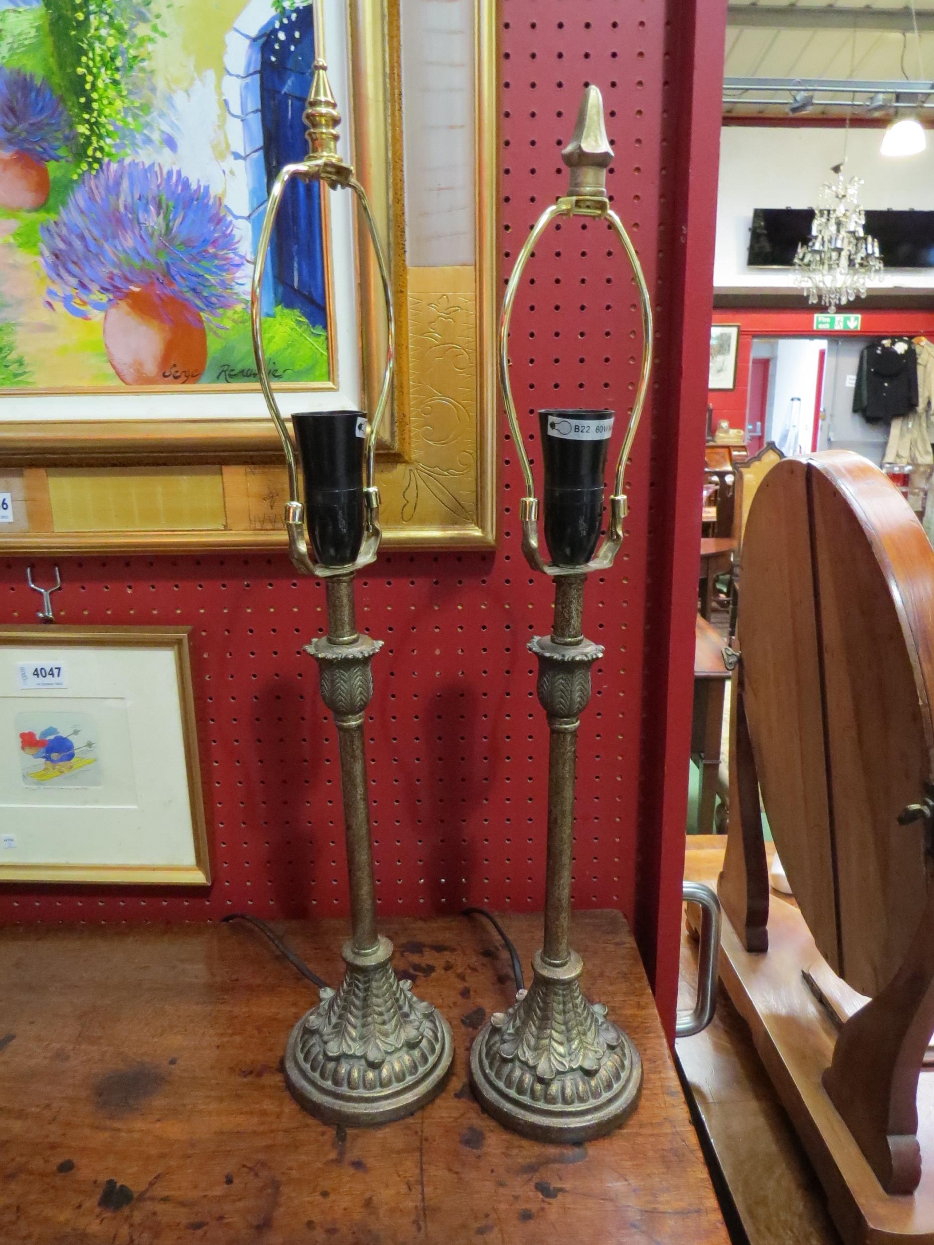 A pair of bronzed effect table lamps with acanthus leaf style decoration