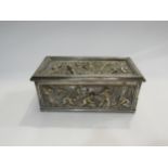 A silver plated lidded box with scenes of farmers