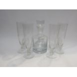 A decanter with stopper together with four etched glass drinking glasses