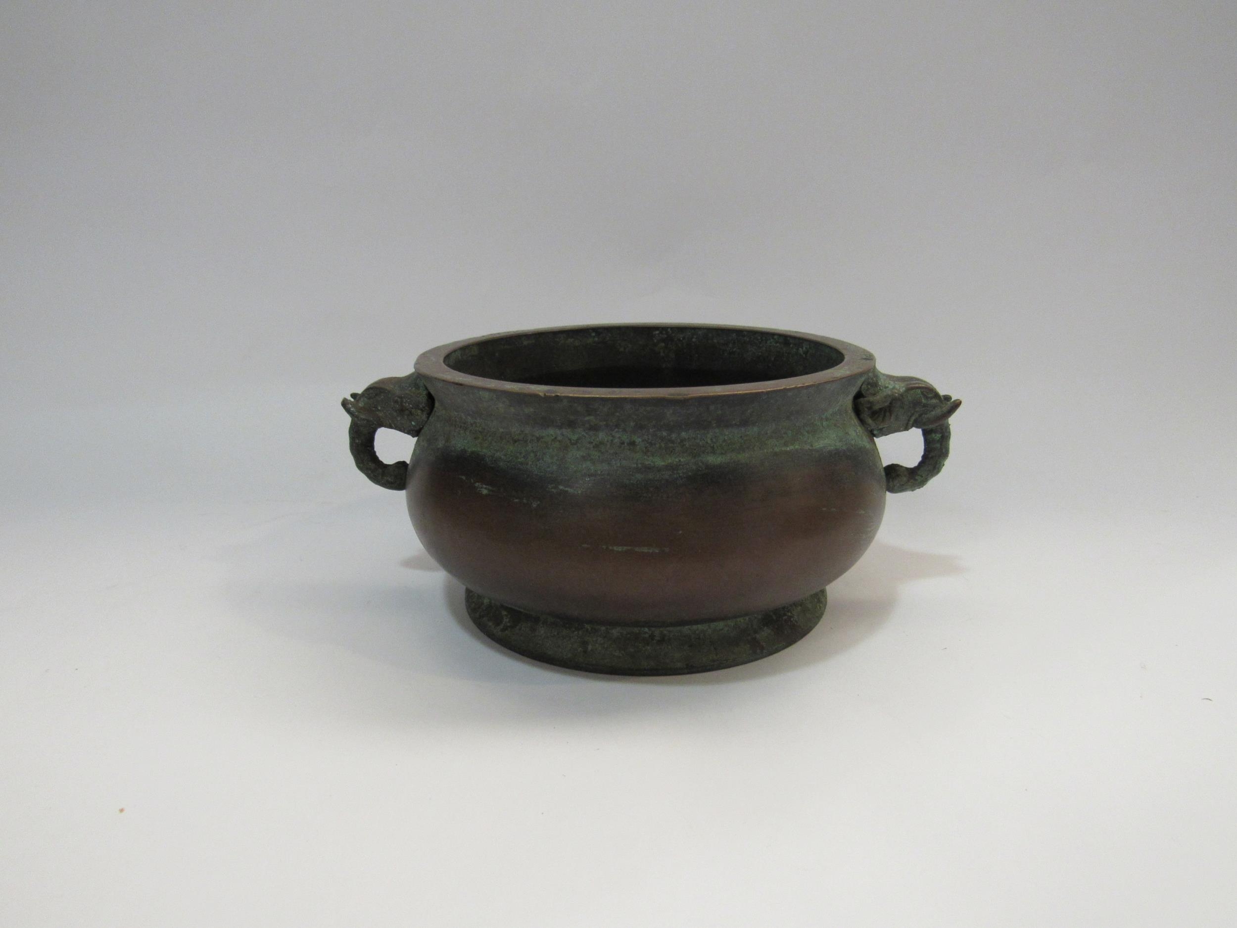 A bronze two handled censor with elephant handles and character marks