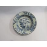 A Chinese blue and white dish with floral design, possibly Kangxi period, restored, 17cm diameter