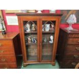 A Victorian mahogany arched glazed two door bookcase with working lock and key the height adjustable
