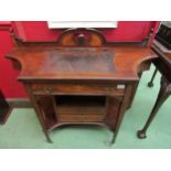 An Edwardian rosewood lady's writing table of breakfront form with shaped gallery back, inset pen