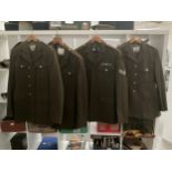 Four post war British army no. 2 service dress jackets and trousers, one with insignia