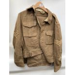 A WWII 1940 pattern battledress blouse with Essex Regiment brass shoulder titles, Sergeant's