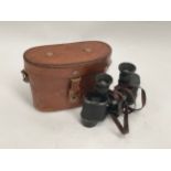 A pair of WWII German Dienstglas Kriegsmarine binoculars with eagle stamp and M, with leather case.