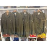 Four post war British army no. 2 service dress jackets, two with trousers, one with insignia