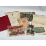 A folder of military ephemera including photographs and service books etc.