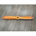 A segmented wood propeller, approx 125cm long.