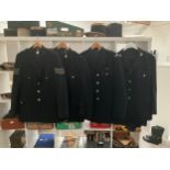 Four British constabulary jackets three with trousers