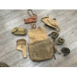 A 1958 dated British Army webbing satchel with contents including wartime cases and leather holster