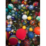 A tin of assorted marbles and balls
