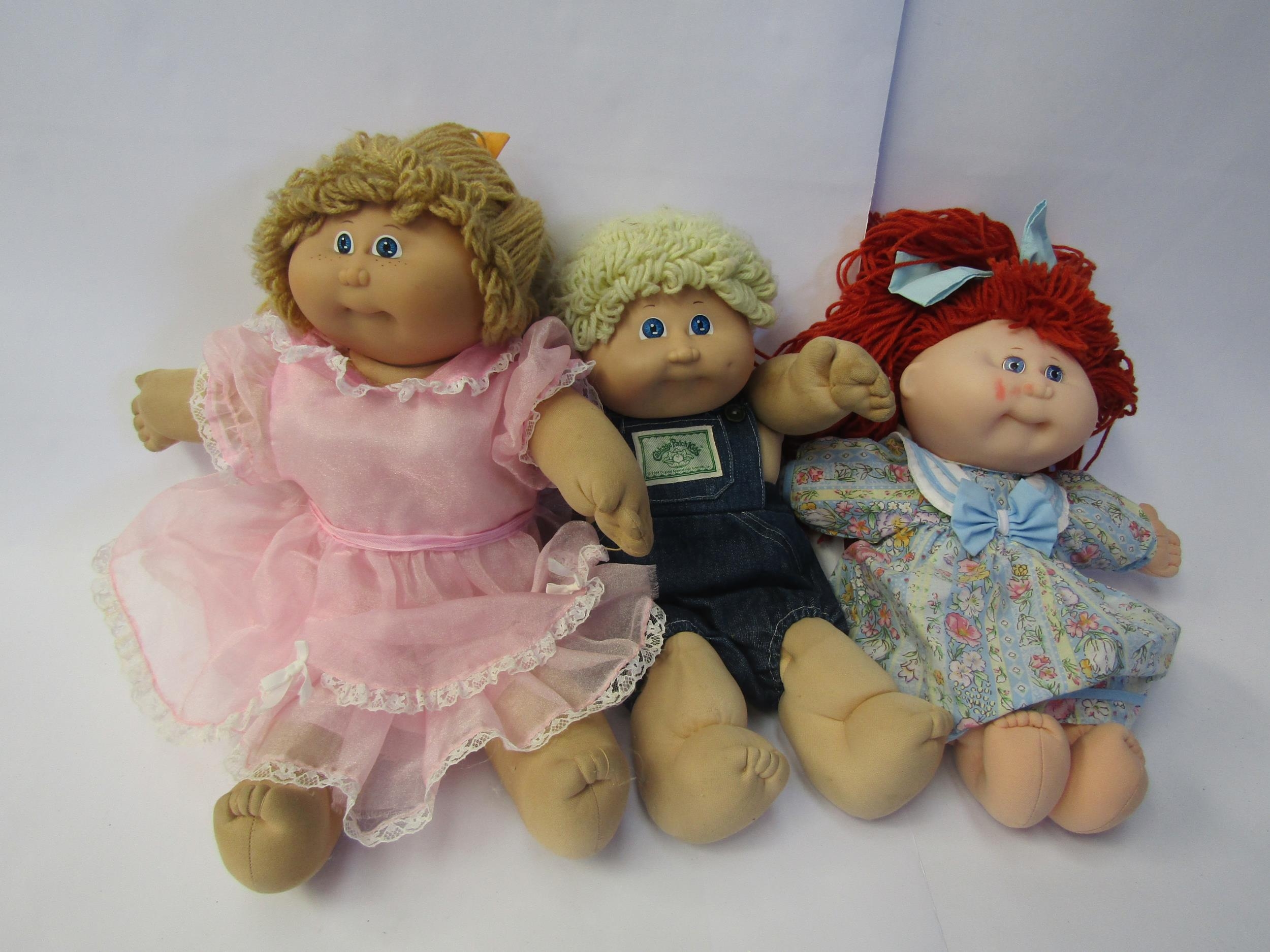 Three Cabbage Patch Kids dolls