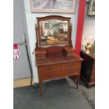 An Edwardian mahogany and satinwood crossbanded dressing chest, the mirror back over drawer front on
