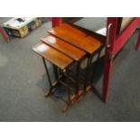 A slender mahogany nest of three tables, fluted form supports