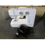 A Janome electric sewing machine model 1560 with instruction booklet