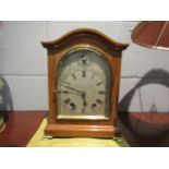 A chiming bracket clock with bevel edged glass door on brass feet, 27cm high