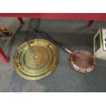 An Eastern brass charger, 59cm diameter, and a copper bed pan with ebonised handle