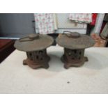 A pair of cast iron Pagoda form tea light holders, approximately 12cm high
