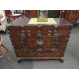 A Korean wooden cabinet with veneered front, two front doors, metal trims, on matching stand, 78cm